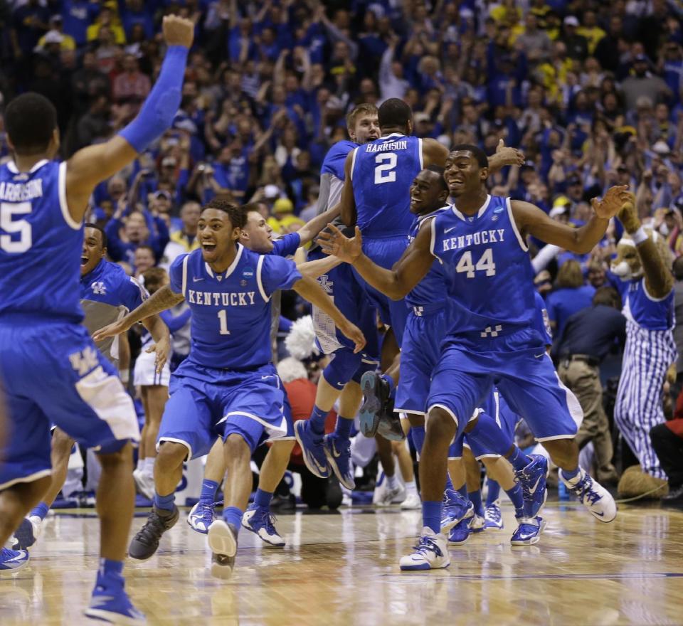 Kentucky players celebrate after an NCAA Midwest Regional final college basketball tournament game against Michigan Sunday, March 30, 2014, in Indianapolis. Kentucky won 75-72 to advance to the Final Four.(AP Photo/Michael Conroy)