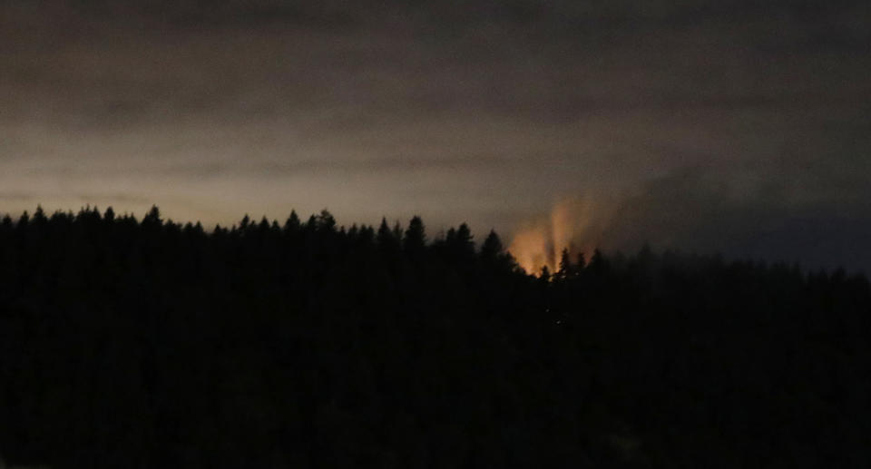 Smoke and an orange glow seen on Ketron Island in Washington state. Source: AP Photo via AAP