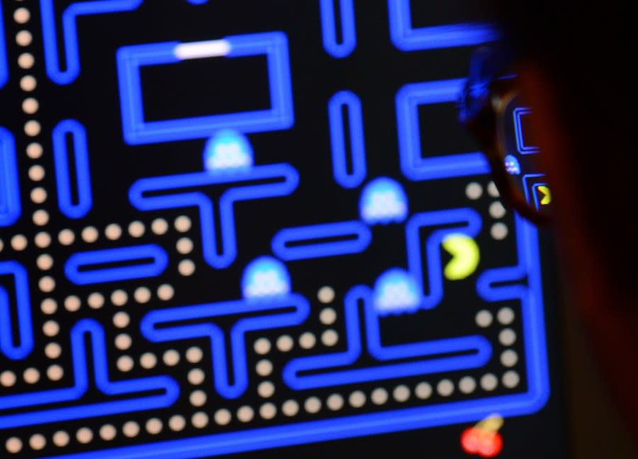 An employee plays the video game Pac-Man (1980) during an exhibition preview featuring 14 video games acquired by The Museum of Modern Art (MoMA) in New York, March 1, 2013. The MoMA acquired 14 video games entering its collection as part of an ongoing research on interaction design. (EMMANUEL DUNAND/AFP via Getty Images)