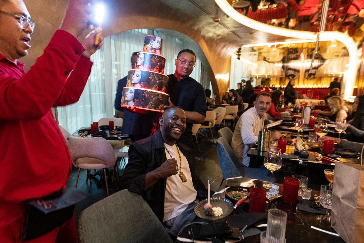 Restaurant staff celebrate guest Joshua Ntukidem's birthday at Experience Zuzu in downtown Detroit on Thursday, Oct. 26, 2023.