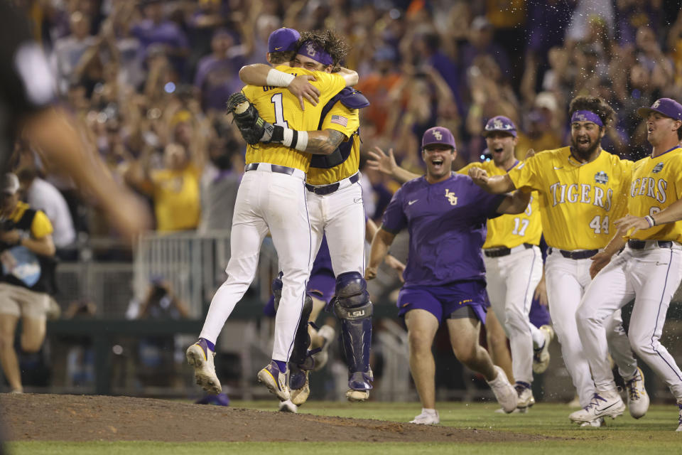 LSU closer Gavin Guidry (1) hugs teammates after defeating Florida in Game 3 of the NCAA College World Series baseball finals in Omaha, Neb., Monday, June 26, 2023. LSU won the national championship 18-4. (AP Photo/Rebecca S. Gratz)