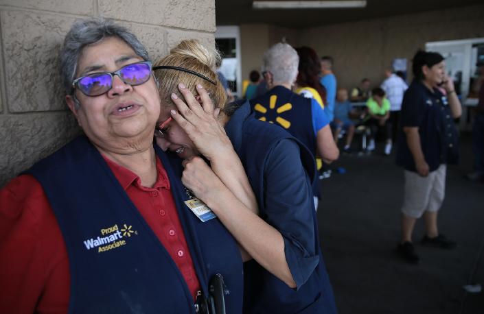 Walmart employees react after a mass shooter opened fire at the store near Cielo Vista Mall in El Paso on Aug, 3, 2019. The admitted white supremacist is facing sentencing this week in federal court for killing 23 El Paso and Juarez residents in the racist attack targeting Hispanics.