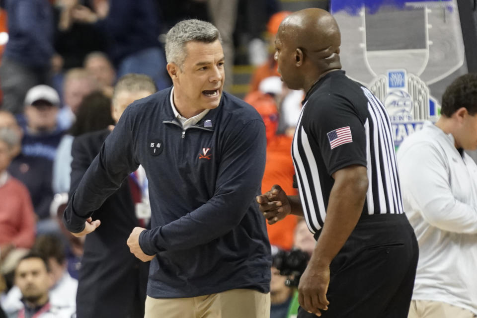 Virginia head coach Tony Bennett, left, argues a call during the first half of an NCAA college basketball game against North Carolina at the Atlantic Coast Conference Tournament in Greensboro, N.C., Thursday, March 9, 2023. (AP Photo/Chuck Burton)
