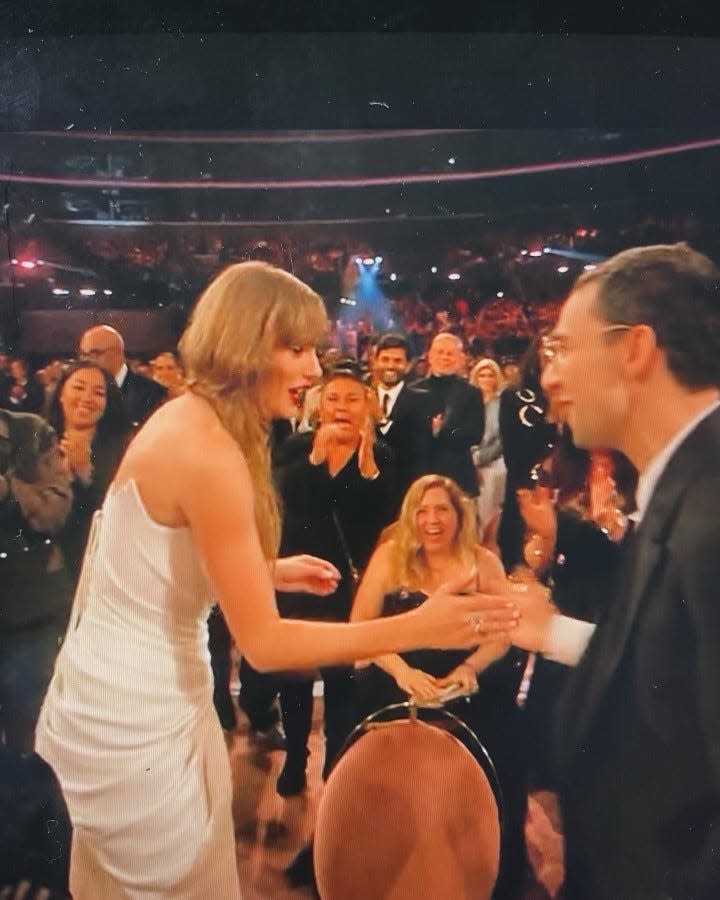 Wisconsinite Katelyn McLaughlin sits above Taylor Swift's and Jack Antonoff's hands in this image from when Swift won album of the year for the fourth time, making Grammys history.