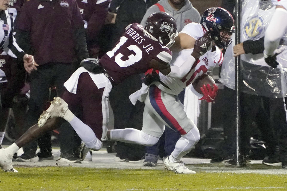 Mississippi wide receiver John Rhys Plumlee (10) is pushed out of bounds by Mississippi State cornerback Emmanuel Forbes (13) during the first half of an NCAA college football game, Thursday, Nov. 25, 2021, in Starkville, Miss. (AP Photo/Rogelio V. Solis)