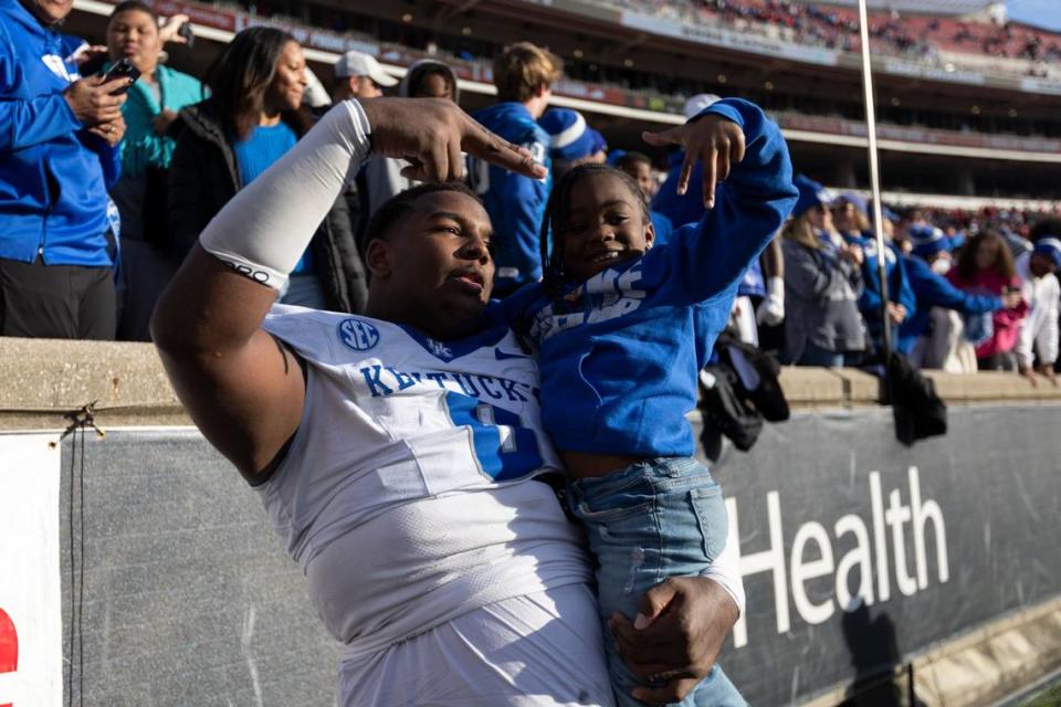 Kentucky defensive tackle Deone Walker (0) celebrated after UK defeated then-No. 9 Louisville 38-31 in the regular-season finale to retain the Governor’s Cup trophy for the fifth consecutive meeting between the Wildcats and Cardinals.