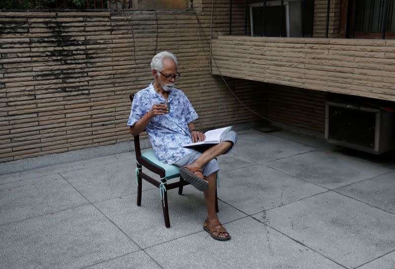 Gopalan Balachandran, maternal uncle of U.S. Senator Kamala Harris' (D-CA) reads a book outside his house in New Delhi