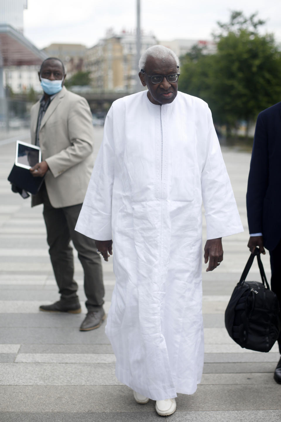 Former president of the IAAF (International Association of Athletics Federations) Lamine Diack arrives at the Paris courthouse, Wednesday, June 10, 2020. A sweeping sports corruption trial opened Monday in Paris involving allegations of a massive doping cover-up that reached to the top of world track and field's governing body. Lamine Diack, 87, who served as president of the body for nearly 16 years, is among those accused of receiving money from Russian athletes to hide their suspected doping so they could compete at the Olympics in 2012 and other competitions. (AP Photo/Thibault Camus)