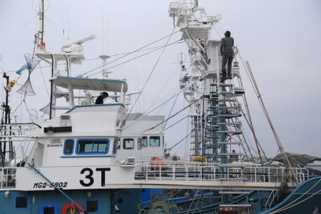 Crew members of a whaling ship which is set to join the resumption of commercial whaling prepare before sailing out at a port in Kushiro, Hokkaido Prefecture