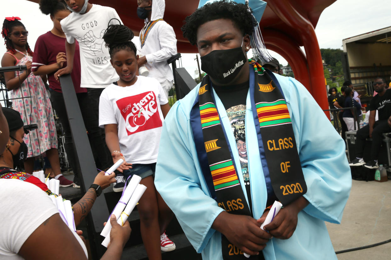 SEATTLE, WA - JUNE 19: Diplomas made by event organizers are handed to recent graduates as they depart the stage during the Juneteenth Freedom March and Celebration on June 19, 2020 in Seattle, Washington. Juneteenth commemorates June 19, 1865, when a Union general read orders in Galveston, Texas stating all enslaved people in Texas were free according to federal law. (Photo by Karen Ducey/Getty Images)