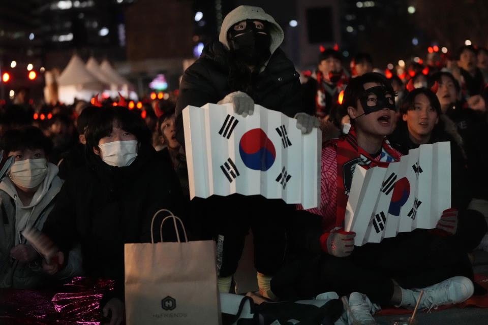 South Korean soccer fans react as they watch a live broadcasting of the Group H World Cup soccer match between South Korea and Portugal in Qatar, at a public viewing venue in Seoul, South Korea, Saturday, Dec. 3, 2022. (AP Photo/Ahn Young-joon)