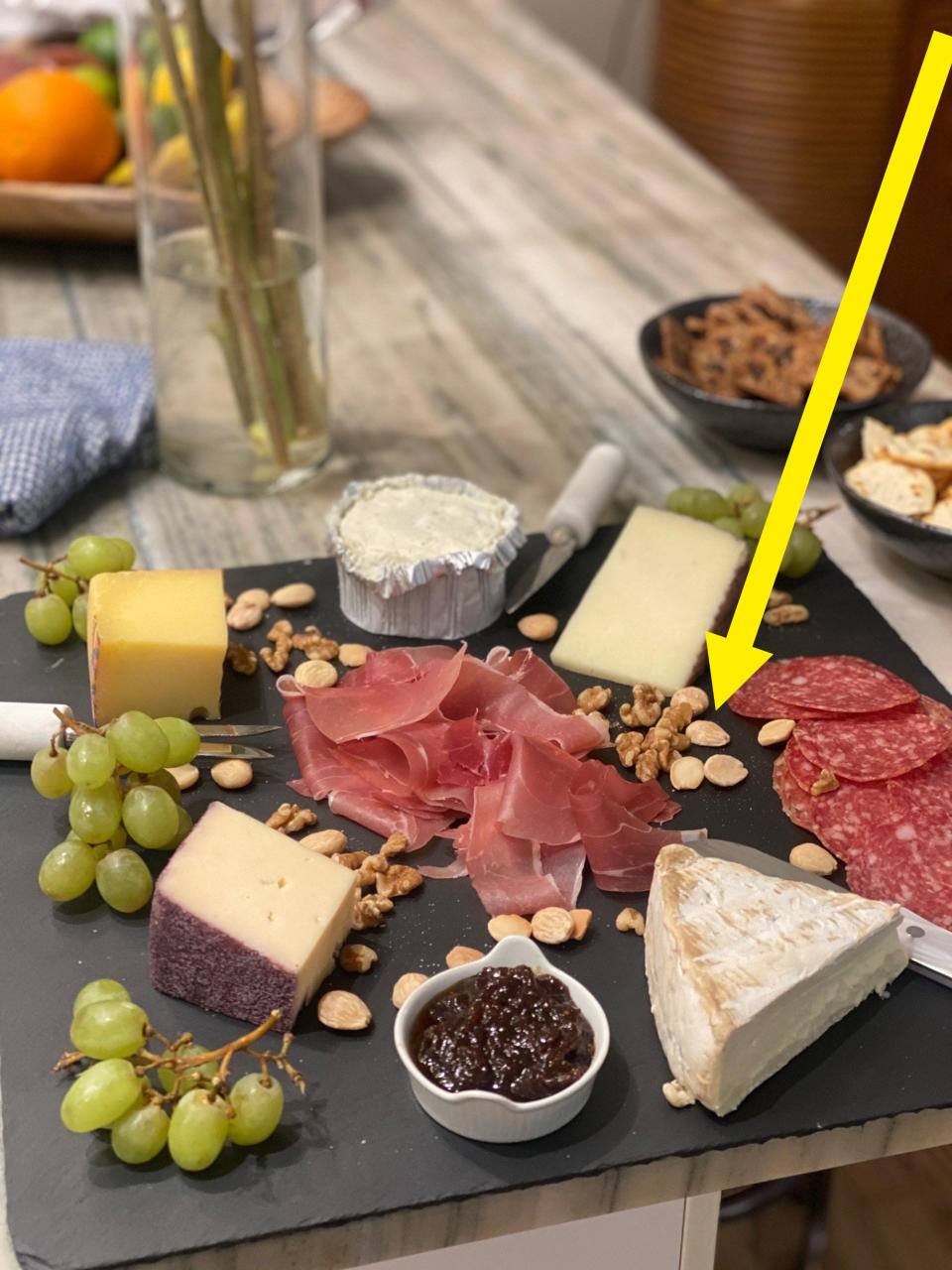 A cheese and charcuterie board with marcona almonds.