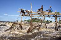 Just outside the city of Kisangani in Tshopo Province in the Democratic Republic of Congo. Fishermen checking their traps for fish in the middle of rapids and strong currents. Everything is built with materials from the jungle. <br><br>Camera: Canon 5D Mark II <br><br>Johnny Haglund, Norway <br><br>Special Mention, Spirit of Adventure