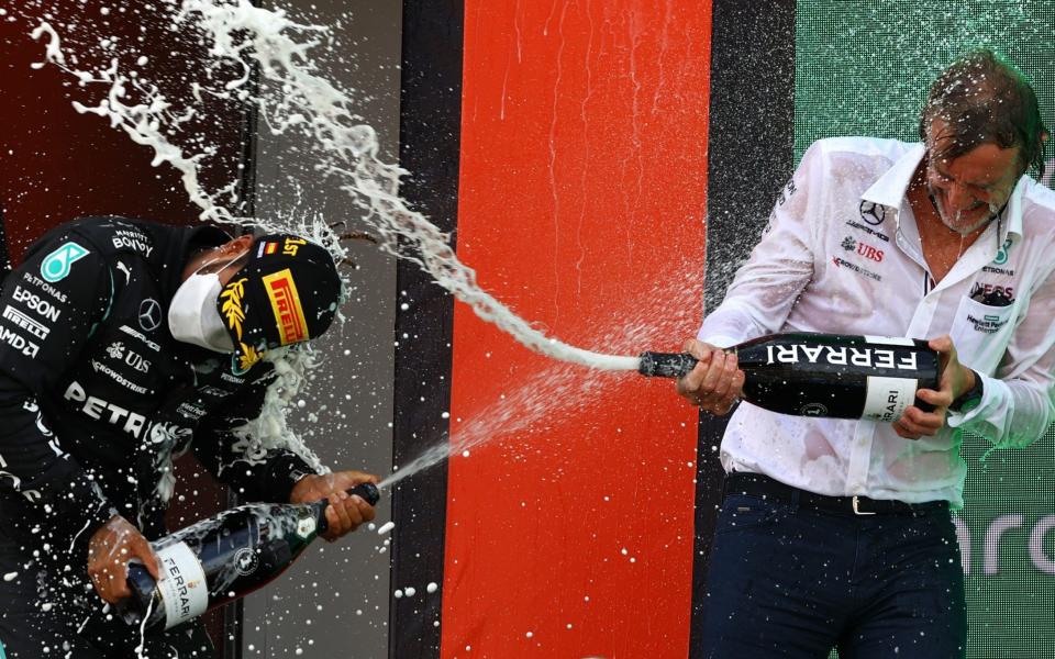 Race winner Lewis Hamilton of Great Britain and Mercedes GP and Ineos CEO Sir Jim Ratcliffe celebrate with sparkling wine on the podium during the F1 Grand Prix of Spain at Circuit de Barcelona-Catalunya on May 09, 2021 in Barcelona, Spain - Bryn Lennon/Getty Images