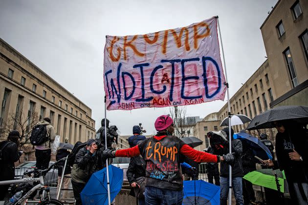 Protestors and members of the press gather outside during a hearing on immunity for former President Donald Trump. The Department of Justice has asked the court to issue a ruling within five days of arguments.