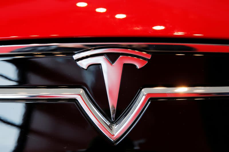 FILE PHOTO: A Tesla logo on a Model S is photographed inside of a Tesla dealership in New York