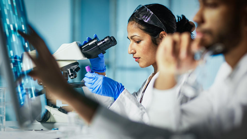 female lab technician working with male lab technician