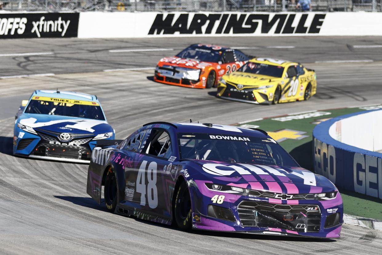 Alex Bowman (48) leads Martin Truex Jr. during the NASCAR Cup race at Martinsville, Va., on Oct. 31, 2021. Bowman spun Denny Hamlin to set up his overtime victory. (AP Photo/Wade Payne)