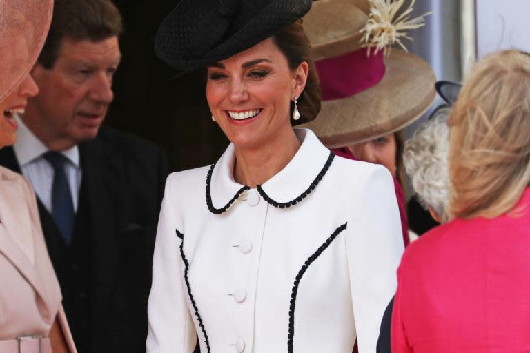 Kate Middleton stepped out with members of the British royal family on Monday afternoon for the Order of the Garter ceremony.The annual event, which celebrates the most senior order of the chivalry in the UK, took place at St George's Chapel in Windsor, and was also attended by The Queen, Prince William and Prince Charles.For the occasion, the duchess cut a chic figure in a perfectly tailored white coat dress with black trim by Catherine Walker, a British label often favoured by the duchess, which was also a go-to designer for her late mother-in-law, Princess Diana.The 'Liza' coat featured a flattering peplum silhouette and is described on the website as: "A contemporary take on a ’50’s look, this coatdress in ivory wool crepe has copped jacket ‘panels’ edged in fine black lace."Kate accessorised the look with contrasting black accessories, including a Lock & Co hat, clutch bag and classic black court shoes with subtle cut-out detail. The duchess finished off the look with a pair of pearl drop earrings by Collingwood jewellers, which belonged to Princess Diana.