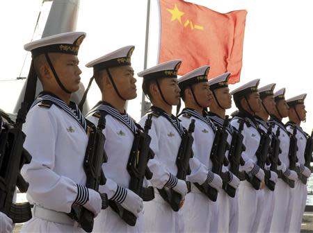 Chinese sailors stand at attention on the helipad of the Chinese frigate Yancheng docked at Limassol port, January 4, 2014. REUTERS/Andreas Manolis