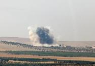 Smoke rises from the Syrian border town of Jarablus as it is pictured from the Turkish town of Karkamis, in the southeastern Gaziantep province, Turkey, August 24, 2016. REUTERS/Stringer