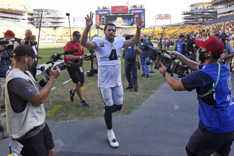 Las Vegas Raiders quarterback Derek Carr (4) waves to fans as he heads to the locker room following an NFL football game against the Pittsburgh Steelers in Pittsburgh, Sunday, Sept. 19, 2021. (AP Photo/Don Wright)