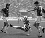 Juventus' Gianluca Vialli, center, vies for the ball with AC Milan's Alessandro Costacurta, left, and Christian Panucci, during their match at San Siro stadium, in Milan, Italy, on Oct. 15, 1995. Gianluca Vialli, the former Italy striker who helped both Sampdoria and Juventus win Serie A and European trophies before becoming a player-manager at Chelsea, has died on Friday, Jan. 6, 2023. He was 58. (AP Photo/Luca Bruno, File)