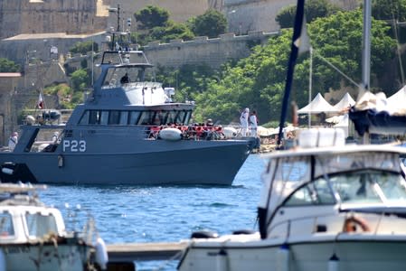 Patrol boats carrying migrants rescued by the Alan Kurdi vessel enter the Maltese harbour