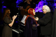 Ricky Skaggs presents Wynonna Judd with her medallion during the Medallion Ceremony at the Country Music Hall of Fame as sister Ashley Judd, left, looks on Sunday, May 1, 2022, in Nashville, Tenn. (Photo by Wade Payne/Invision/AP)