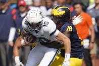 Michigan linebacker Eyabi Anoma (18) sacks Connecticut quarterback Cale Millen (10) in the second half of an NCAA college football game in Ann Arbor, Mich., Saturday, Sept. 17, 2022. (AP Photo/Paul Sancya)