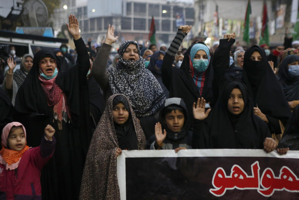 Shiite Muslims chant slogans during a sit-in to protest the killing of coal mine workers by gunmen near the Machh coal field, in Lahore, Pakistan, Wednesday, Jan. 6, 2021. Pakistan's minority Shiites continued their sit-in for a fourth straight day insisting they will bury their dead only when Prime Minister Imran Khan personally visits them to assure protection. (AP Photo/K.M. Chaudary)