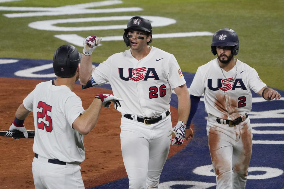 United States' Triston Casas (26) celebrate with Todd Frazier, left, and Eddy Alvarez right afterhitting a two run home run during the fourth inning of a baseball game against South Korea at the 2020 Summer Olympics, Saturday, July 31, 2021, in Yokohama, Japan. (AP Photo/Sue Ogrocki)