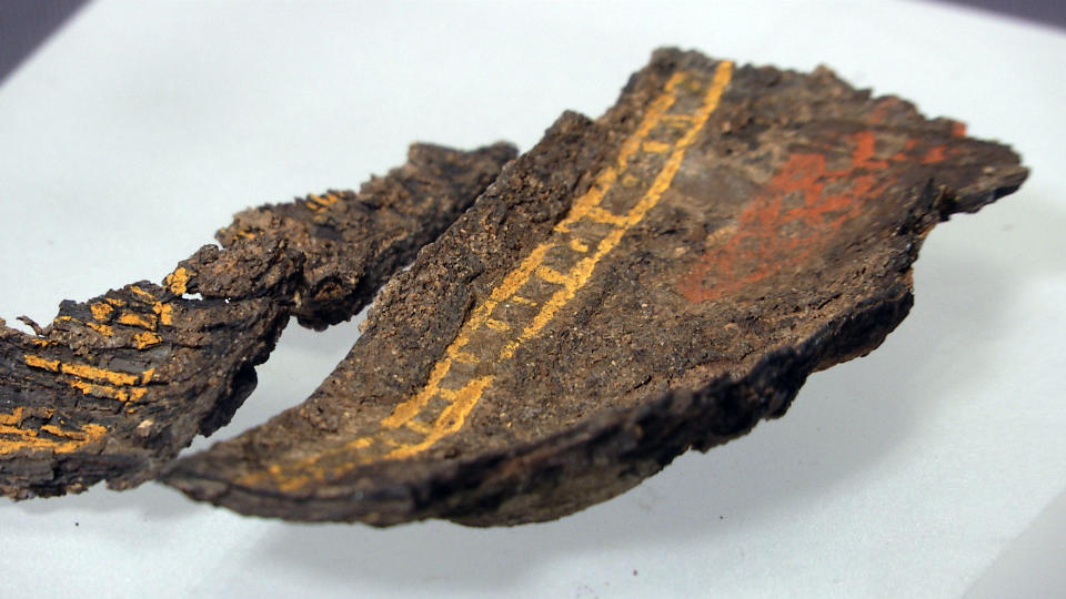 A painted wooden box fragment, claimed to be the only surviving example of early Anglo-Saxon painted woodwork, on display at Southend Central Museum in Southend, England, Thursday, May 8, 2019. Archaeologists say an underground chamber discovered accidentally by road workers may be the site of the earliest Christian royal burial in Britain. The chamber uncovered between a road and a railway line in the village of Prittlewell in 2003 turned out to be a 1,400-year-old burial site. (AP Photo/James Brooks)