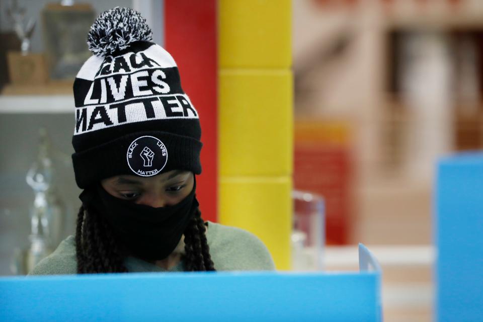 First-time voter Alexis Gresham, 23, casts her ballot Nov. 3, 2020, at Clarke Central High School in Athens, Ga.