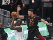 Charlotte Hornets center Bismack Biyombo, left, is fouled by Cleveland Cavaliers forward Larry Nance Jr. (22) as he drives to the basket during the second quarter of an NBA basketball game in Charlotte, N.C., Wednesday, April 14, 2021. (AP Photo/Nell Redmond)
