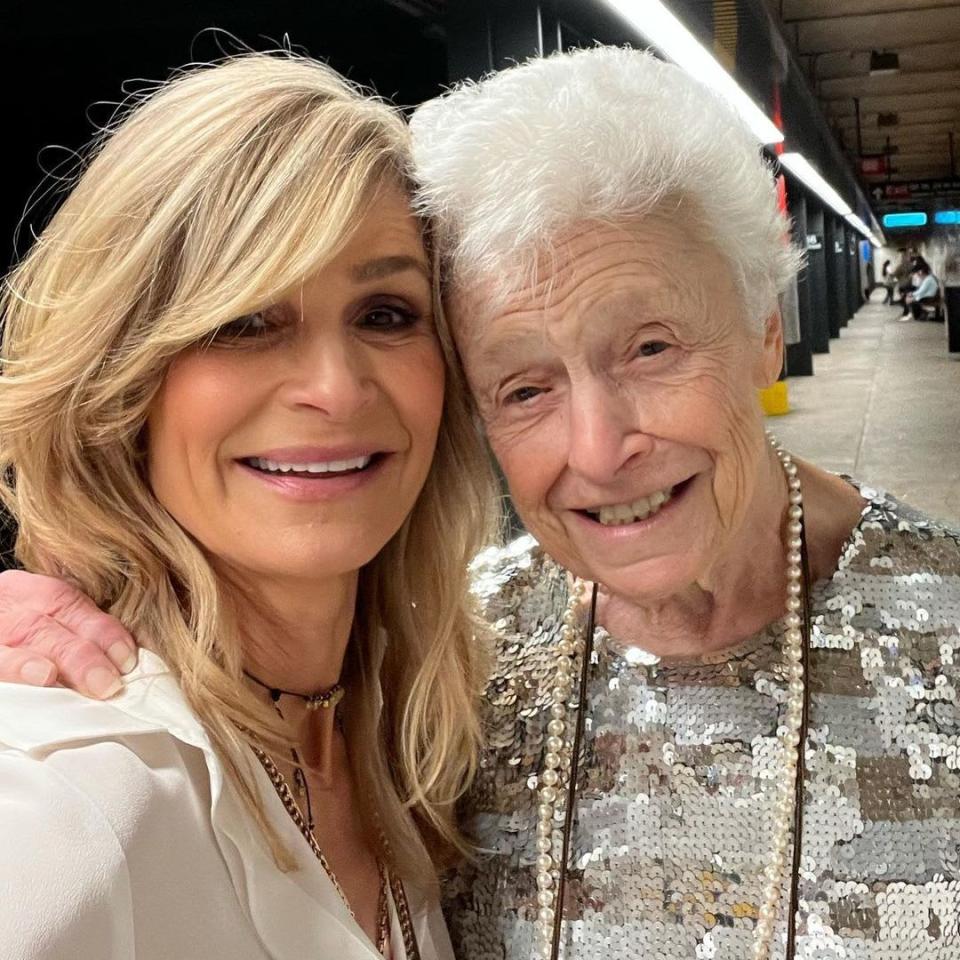 Kyra and Patricia smiling for a selfie together at a subway station