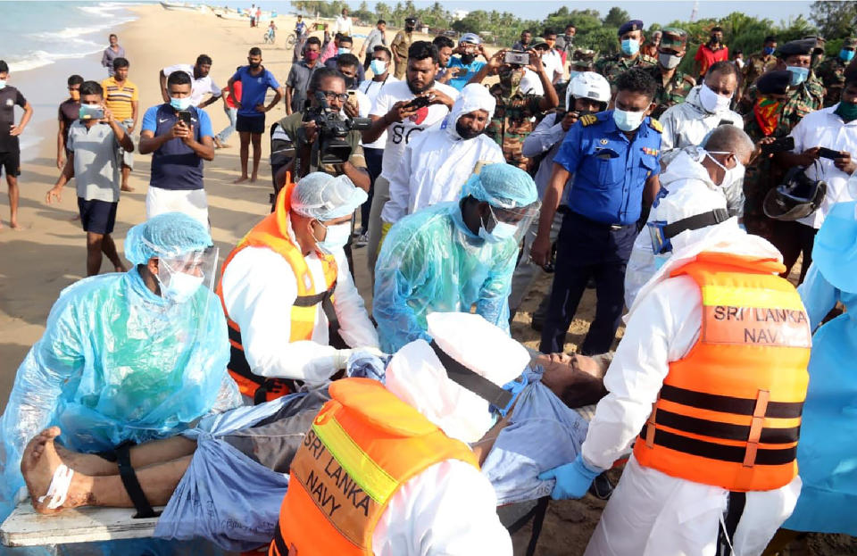 In this photo provided by Sri Lanka Navy, an injured crew member of the MT New Diamond, is transferred on stretcher to an ambulance Thursday, Sept. 3, 2020, in Sangamankanda, Sri Lanka. A flotilla from Sri Lanka and India was escalating efforts to douse a fire raging on the oil tanker east of Sri Lanka for a second day Friday. The fire started Thursday in an engine room boiler on the MT New Diamond, leaving one crew member injured and one missing.(Sri Lanka Navy via AP)