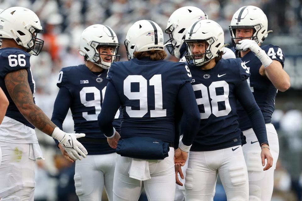 Nov 13, 2021; University Park, Pennsylvania, USA; Penn State Nittany Lions kicker Jordan Stout (98) is congratulated by teammates after kicking a field goal during the first quarter against the Michigan Wolverines at Beaver Stadium. Mandatory Credit: Matthew OHaren-USA TODAY Sports