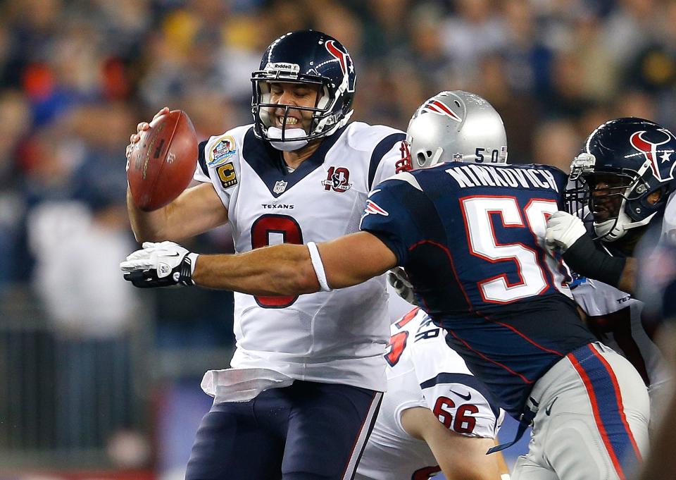 Matt Schaub #8 of the Houston Texans is chased by Rob Ninkovich #50 of the New England Patriots in the first half at Gillette Stadium on December 10, 2012 in Foxboro, Massachusetts. (Photo by Jim Rogash/Getty Images)
