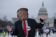 <p>A demonstrator wearing a mask of President Trump dances as others march past the US Capitol during the Women’s March on Washington, D.C., January 21, 2017. (JIM WATSON/AFP/Getty Images) </p>