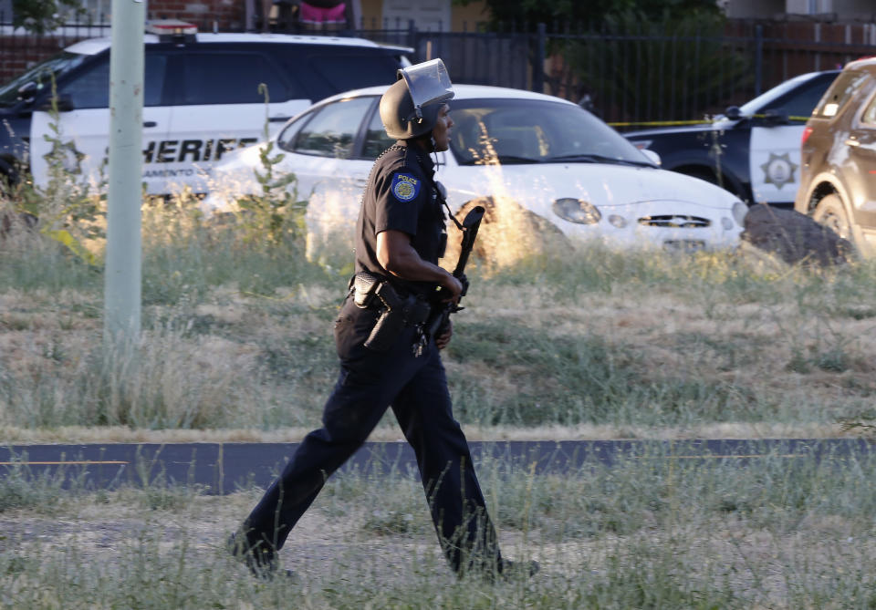 A Sacramento Police officer responds to the shooting of a fellow officer in Sacramento, Calif., Wednesday, June 19, 2019. (AP Photo/Rich Pedroncelli)