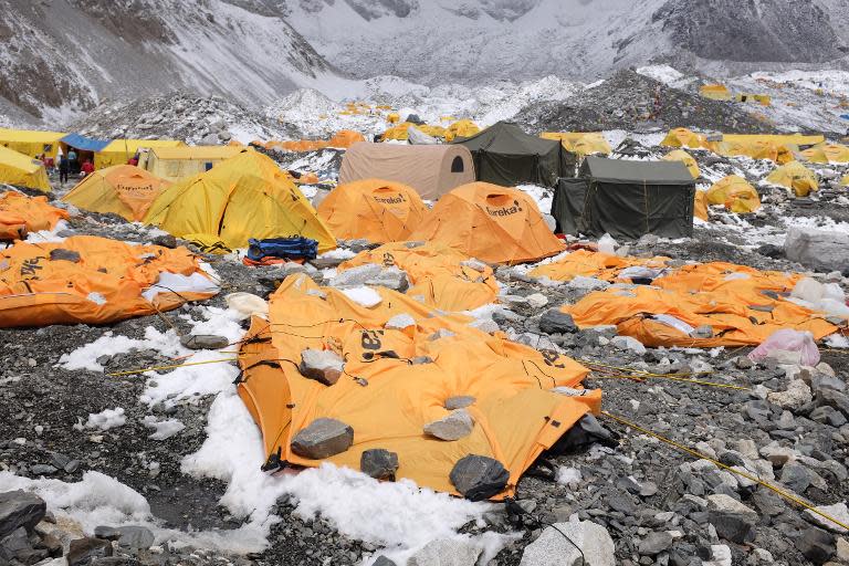 Rocks are kept over flattened tents at Everest Base Camp to cover the bodies of some of the people that died in the earthquake-triggered avalanche, April 26, 2015