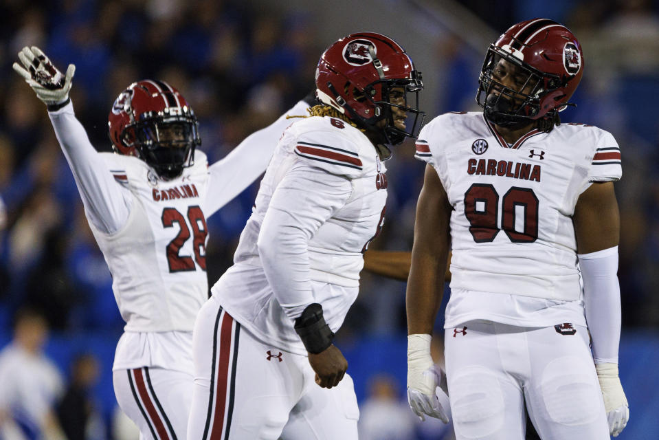 South Carolina defensive lineman Zacch Pickens (6), defensive lineman T.J. Sanders (90) and defensive back Darius Rush (28) celebrate after a block of a Kentucky punt during the first half of an NCAA college football game in Lexington, Ky., Saturday, Oct. 8, 2022. (AP Photo/Michael Clubb)