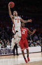 Florida guard Chris Chiozza (11) goes up for a shot against Wisconsin guard Khalil Iverson (21) in overtime of an East Regional semifinal game of the NCAA men's college basketball tournament, Saturday, March 25, 2017, in New York. (AP Photo/Frank Franklin II)