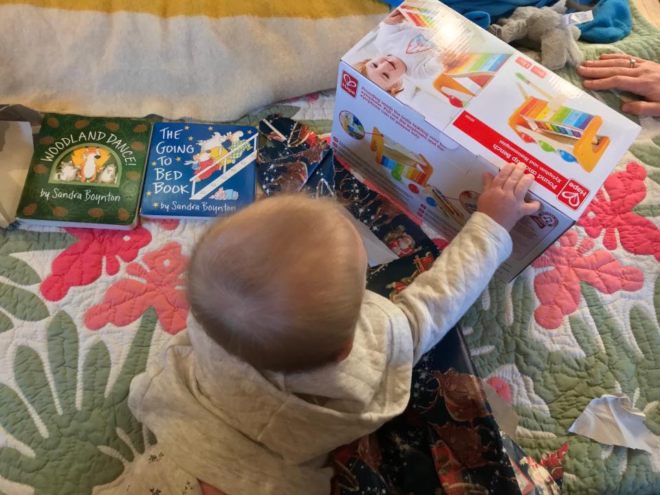 The baby in the Salem family opens a holiday gift.<span class="copyright">Courtesy photo</span>