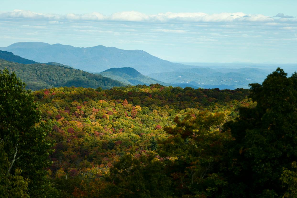 Leaves begin to change in the Blue Ridge Mountains seen from Sassafras Mountain on Tuesday, Oct. 23, 2023.