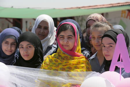 Nobel Peace Prize laureate Malala Yousafzai (C) poses with girls for a picture at a school for Syrian refugee girls, built by the NGO Kayany Foundation, in Lebanon's Bekaa Valley July 12, 2015. REUTERS/Jamal Saidi