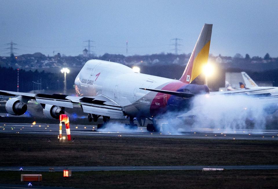 A Boeing 747 of Asiana Airlines lands at the airport in Frankfurt, Germany, Sunday, March 1, 2020. The aviation industry expects heavy financial losses due to the Covid-19 virus. (AP Photo/Michael Probst)