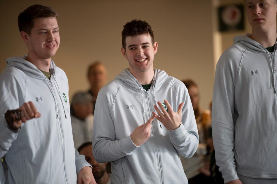 Colorado State men's basketball team players Adam Thistlewood and Nick Bassett (right) react during an March 2022 NCAA Tournament selection show watch party at Canvas Stadium in Fort Collins.