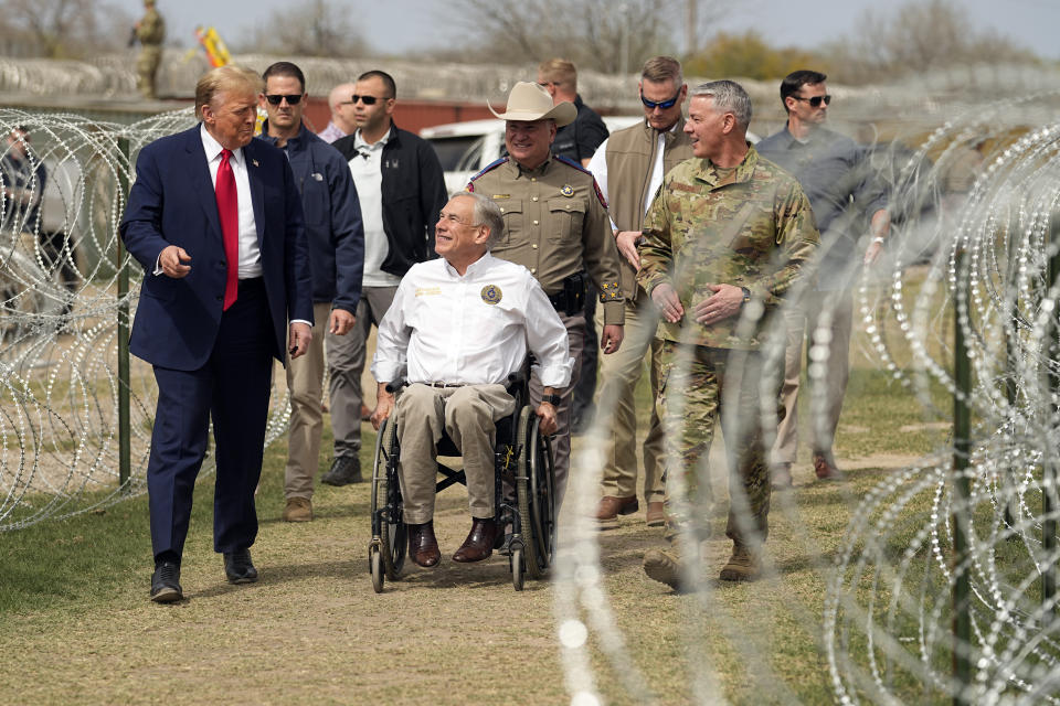 FILE - Republican presidential candidate former President Donald Trump talks with Texas Gov. Greg Abbott during a visit to the U.S.-Mexico border, Feb. 29, 2024, in Eagle Pass, Texas. (AP Photo/Eric Gay, File)